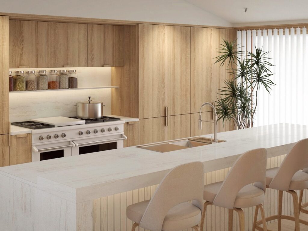 a kitchen complete with hob, sink and chairs
